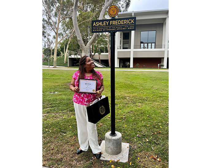 Ashley Frederick admiring her sign on Friendship Walk